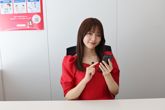 スマートフォンを手にするIBJ婚活アンバサダーの森香澄さん