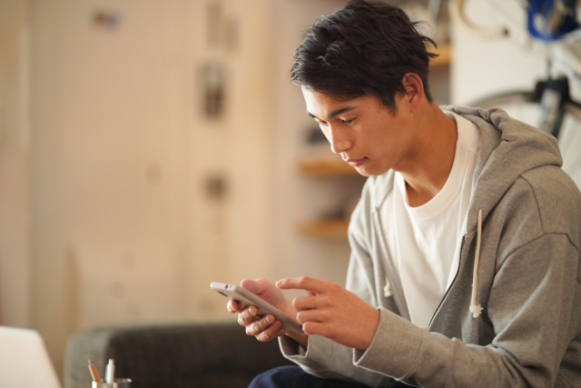 スマートフォンでメールを送ろうとしている男性
